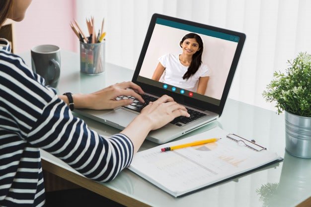 A speech therapist conducting an online speech therapy session with a female patient