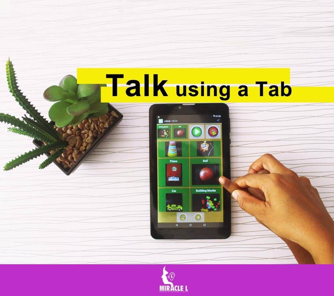 Child being taught by a speech therapist to use a tab (AAC) to communicate also know as Augmentative & Alternative Communication